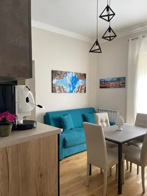 a living room with a blue couch and a table at Luxury Apartament's Celso in Palermo