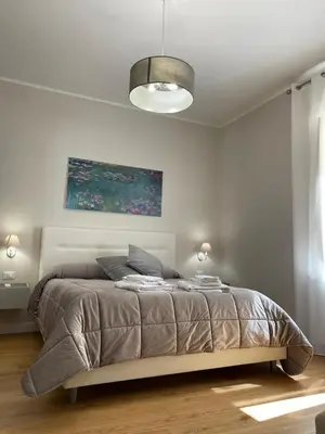 a bedroom with a bed in a white room at Luxury Apartament's Celso in Palermo