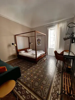 a bedroom with a canopy bed in a room at B&B TIVÌTTI in Palermo