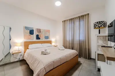 a bedroom with a bed with two towels on it at Tarzanà 11 apartment - Cala di Palermo in Palermo