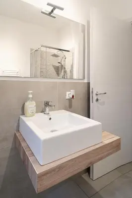 a bathroom with a white sink and a mirror at Tarzanà 11 apartment - Cala di Palermo in Palermo