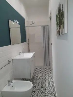 a white bathroom with a sink and a toilet at Airport Home TUREI & BRINGO Car Rental in Cinisi