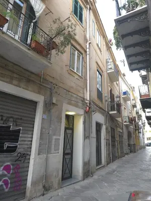 a building with graffiti on the side of a street at Luxury Apartament's Celso- in Palermo