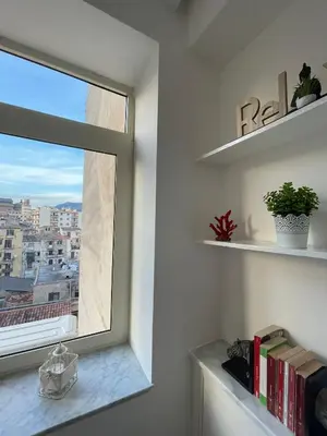 a window in a room with a book shelf at Luxury Apartament's Celso- in Palermo