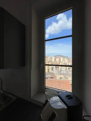 a window in a room with a view of a city at Luxury Apartament's Celso- in Palermo