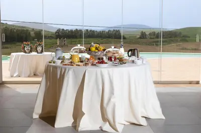 a table with a white table cloth with food on it at La Corte del Sole in Calatafimi