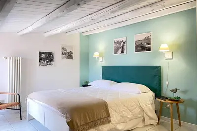 a bedroom with a large bed and a blue wall at Mondello in Terrazza by DomuSicily in Mondello