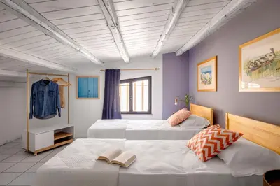 a bedroom with two beds in a room at Mondello in Terrazza by DomuSicily in Mondello