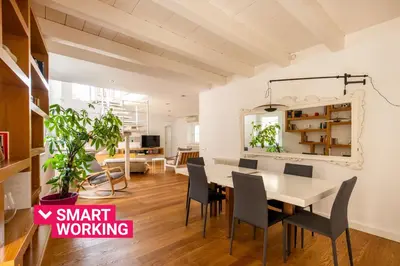 a white bedroom with a bed and a chair at Vittorio Emanuele apartment with terrace by Wonderful Italy in Palermo