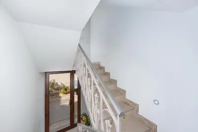 a staircase in a house with a glass door at B&B A casa di Aurora rooms in San Vito lo Capo
