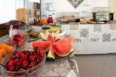 a buffet with bowls of fruits and vegetables on a table at B&B A casa di Aurora rooms in San Vito lo Capo