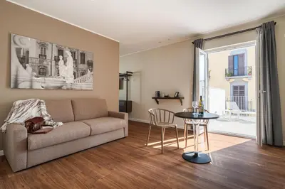 a living room with a couch and a table at Attico 37 - Suite con terrazza privata e cucina in Palermo