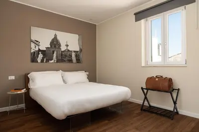 a bedroom with a large white bed and a window at Attico 37 - Suite con terrazza privata e cucina in Palermo