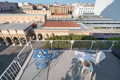 a view of a balcony with a table and a chair at Attico 37 - Suite con terrazza privata e cucina in Palermo