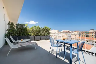 a patio with two tables and chairs on a balcony at Attico 37 - Comfort room con terrazza privata in Palermo