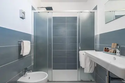 a bathroom with a shower and a toilet and a sink at Attico 37 - Comfort room con terrazza privata in Palermo