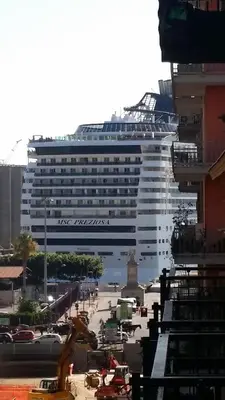 a large cruise ship is docked in a city at Bed & Breakfast Amari 58 in Palermo