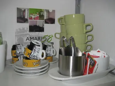 a shelf with cups and plates on a counter at Bed & Breakfast Amari 58 in Palermo