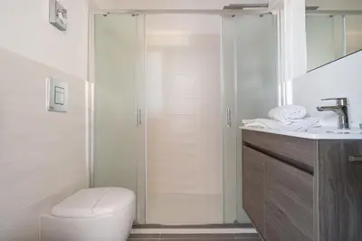 a bathroom with a shower and a toilet and a sink at Attico 37 - Comfort room con terrazza privata in Palermo