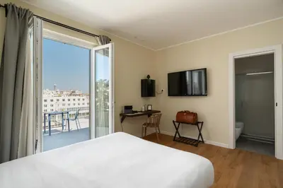 a bedroom with a bed and a sliding glass door at Attico 37 - Comfort room con terrazza privata in Palermo