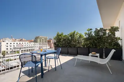 a patio with a table and chairs on a balcony at Attico 37 - Comfort room con terrazza privata in Palermo