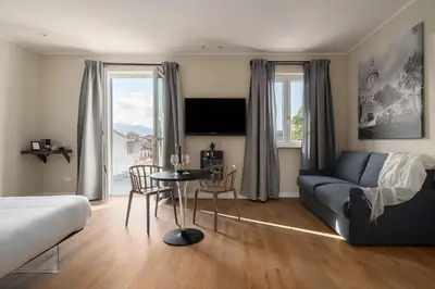 a living room with a couch and a table with chairs at Attico 37 - Queen room con terrazza privata in Palermo