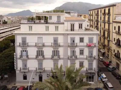 a white building with balconies and a street at Attico 37 - Queen room con terrazza privata in Palermo