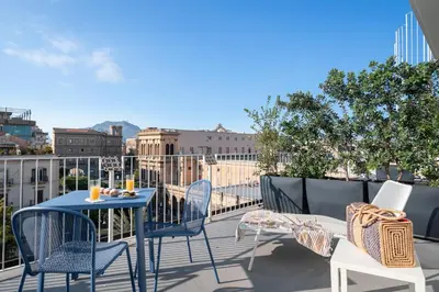 a patio with a table and chairs on a balcony at Attico 37 - Queen room con terrazza privata in Palermo