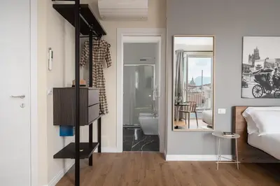 a bedroom with a bed and a bathroom at Attico 37 - Queen room con terrazza privata in Palermo