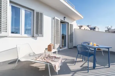 a patio with a table and chairs on a balcony at Attico 37 - Queen room con terrazza privata in Palermo