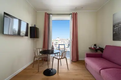 a living room with a purple couch and a table at Attico 37 - Queen room con terrazza privata in Palermo