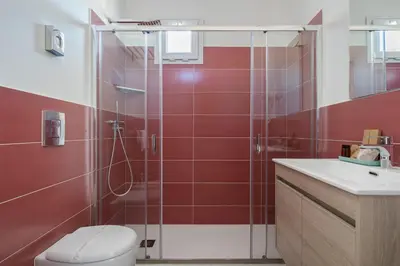 a bathroom with a shower and a toilet and a sink at Attico 37 - Queen room con terrazza privata in Palermo