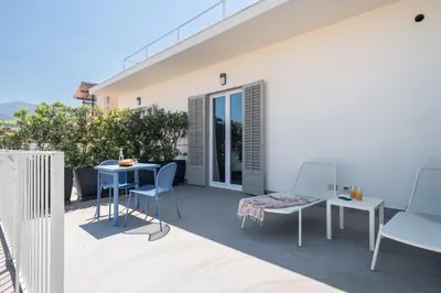 a patio with chairs and a table on a balcony at Attico 37 - Queen room con terrazza privata in Palermo