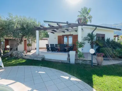 a house with a pergola and a patio at Villa New Charme in Castellammare del Golfo