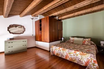 a bedroom with a bed and a dresser at Casa Meli dietro Piazza San Domenico by Wonderful Italy in Palermo