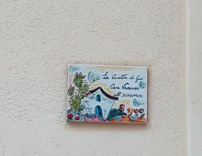 a sign on a wall with a house on it at La Casetta di Giò! in Castellammare del Golfo