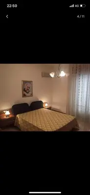 a bedroom with a bed with two lights on it at Villa con piscina 
