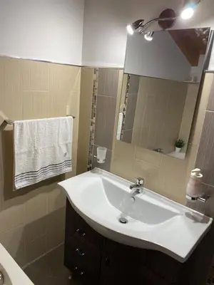a bathroom with a white sink and a mirror at HELIOS House in Palermo