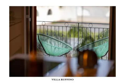 two green glass chairs sitting on a balcony at Appartamento in Villa con idromassaggio in Balestrate
