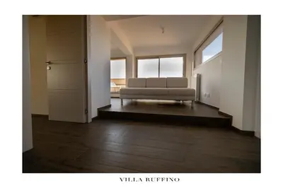 a living room with a couch and some windows at Appartamento in Villa con idromassaggio in Balestrate