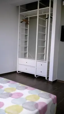 a room with a white closet with shelves and a rug at Appartamento in Villa con idromassaggio in Balestrate