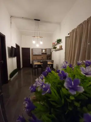 a living room with a table and a dining room at Giovenchi’s Apartment in Palermo