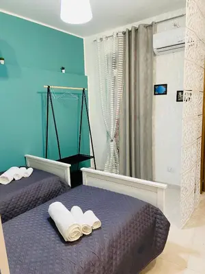 a bedroom with two beds with towels on them at LA CASA DI TABBi in Palermo