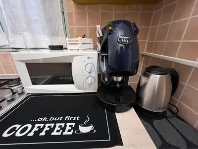 a coffee machine sitting next to a microwave at LA CASA DI TABBi in Palermo