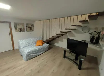 a living room with a couch and a staircase at Casa Costantino in Alcamo
