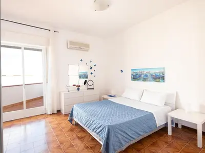 a white bedroom with a bed and a window at Pasqua 2026 già disponibile Dune Home in una Fantastica soluzione con vista mare dalla veranda in Alcamo
