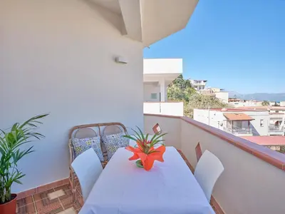 a living room with a white table and chairs at Pasqua 2026 già disponibile Dune Home in una Fantastica soluzione con vista mare dalla veranda in Alcamo