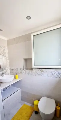 a bathroom with a white toilet and a sink at Via Roma 35 Apartament in Monreale
