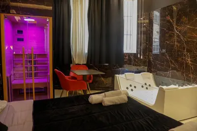 a showroom with a tv and a table with green lighting at Nuar suite&spa in Palermo