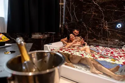 a hotel room with two beds and a table at Nuar suite&spa in Palermo
